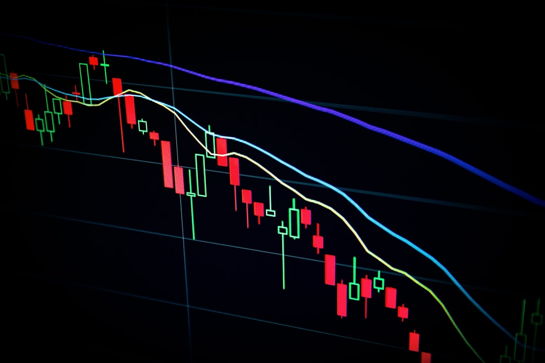 A trader analyzes stock prices on a laptop in a market simulation